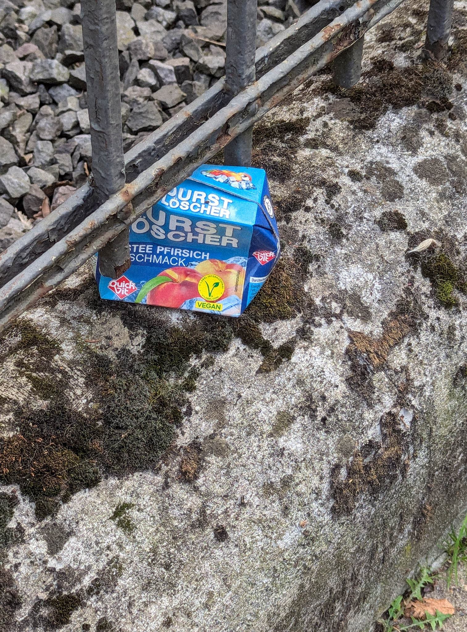 Peach iced tea under a railing