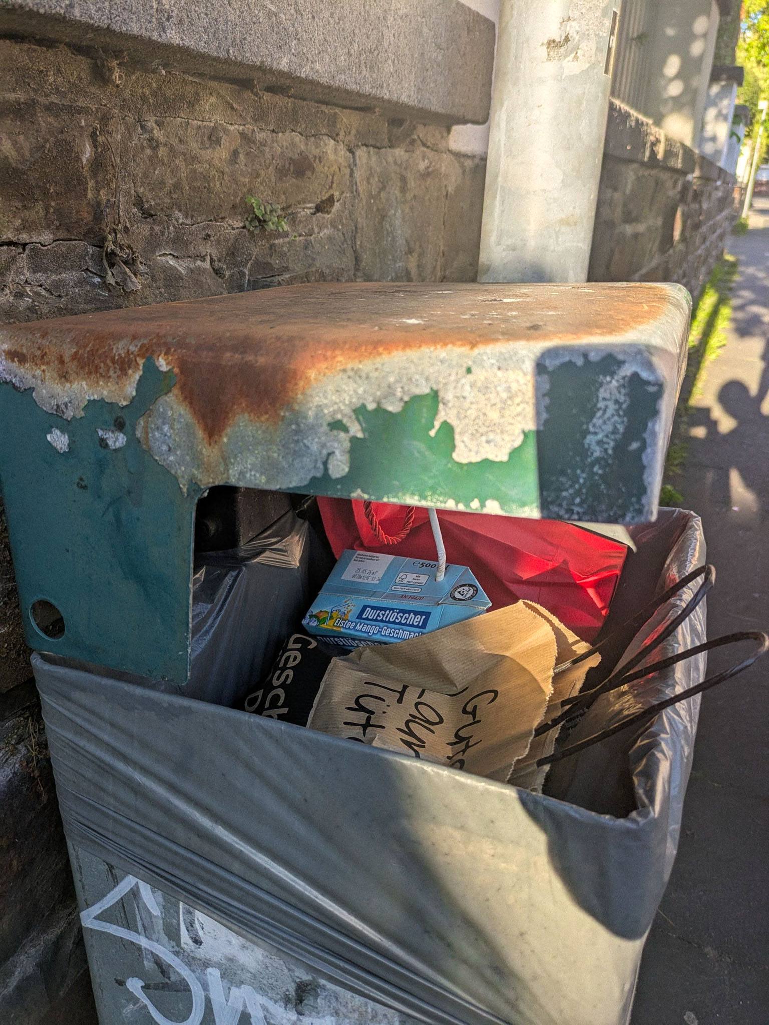 Mango iced tea in the trash